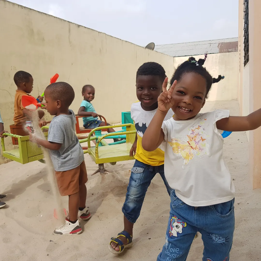 Children laughing and playing on the school terrace