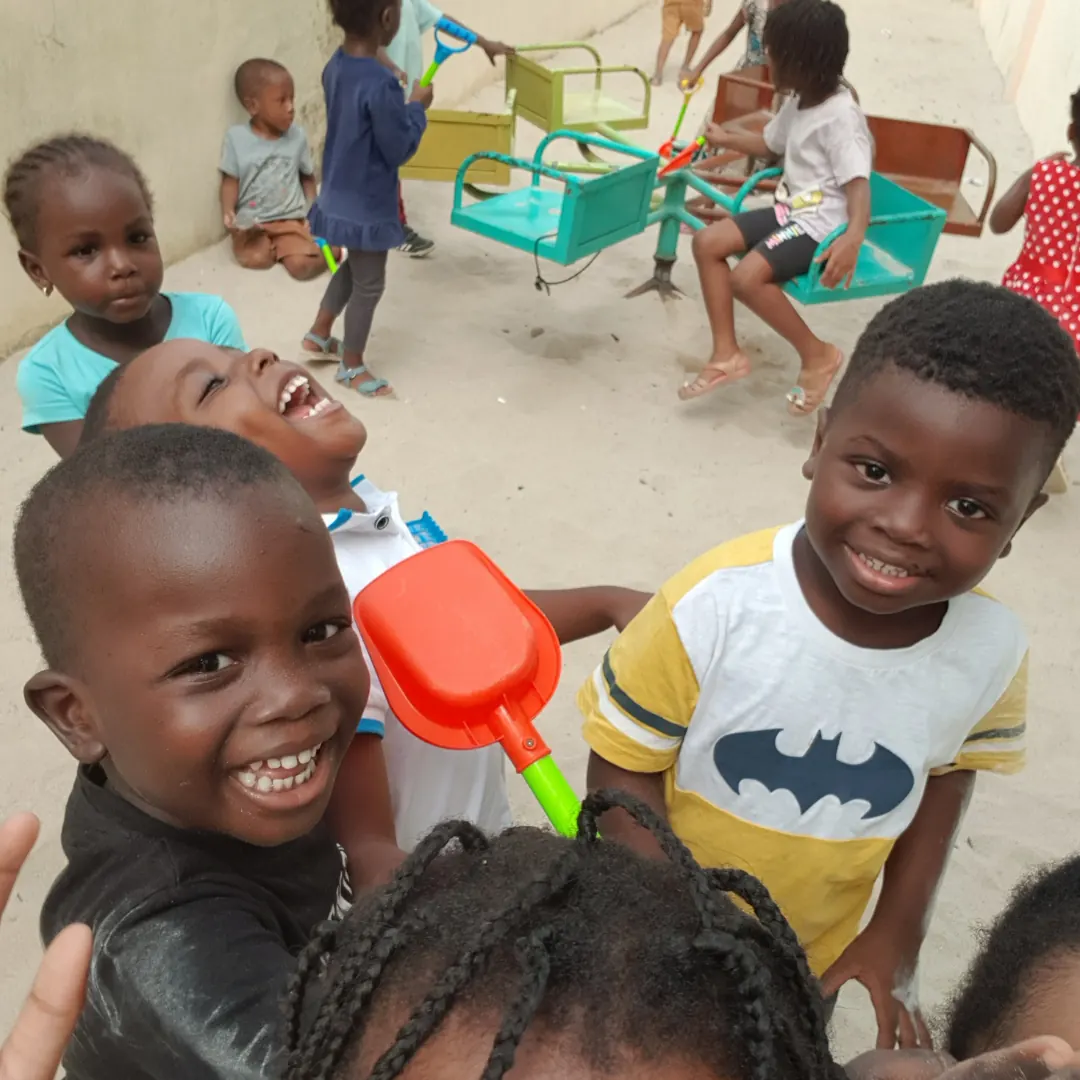 Happy children playing with toys in the sand