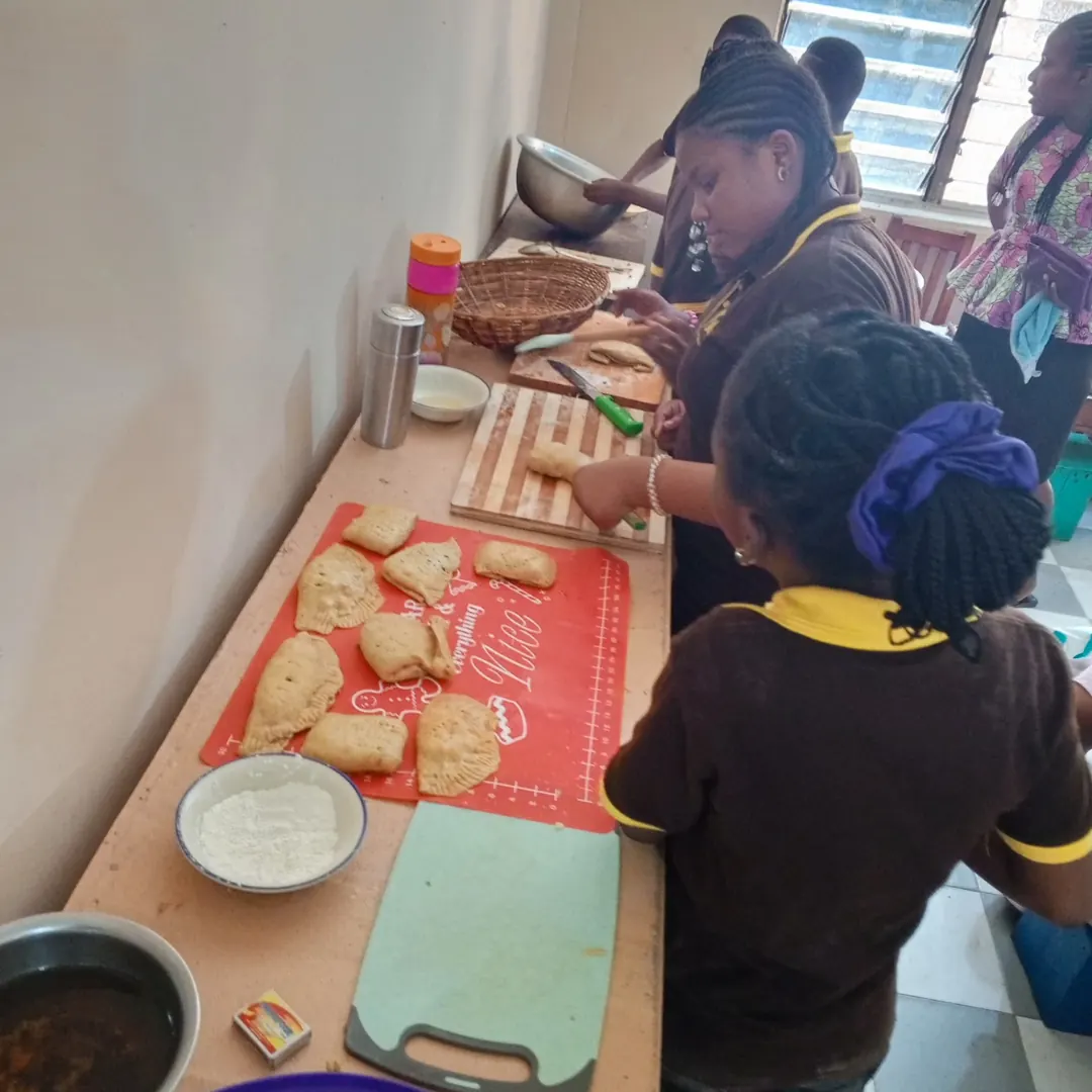 Pupils preparing bread and food together in a cooking activity